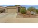 Charming single-story home featuring a two-car garage and desert landscaping at 42266 W Sparks Dr, Maricopa, AZ 85138