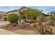 Front yard with desert landscaping and mature trees at 42266 W Sparks Dr, Maricopa, AZ 85138