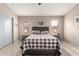 Cozy main bedroom featuring neutral tones, soft rug, and a large bed at 42266 W Sparks Dr, Maricopa, AZ 85138