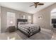 The main bedroom is spacious with a ceiling fan and neutral decor at 42266 W Sparks Dr, Maricopa, AZ 85138