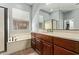 A main bathroom with a large vanity, soaking tub and tile flooring at 4914 E Palm Beach Dr, Chandler, AZ 85249