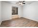 Empty bedroom featuring luxury vinyl floors, ceiling fan, and window with bench seating at 5303 N 7Th St # 109, Phoenix, AZ 85014