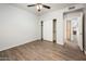 An empty bedroom with luxury vinyl floors, closet, and a ceiling fan at 5303 N 7Th St # 109, Phoenix, AZ 85014