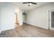 Large open living room with wood floors, access to the patio, and an open kitchen nearby at 5303 N 7Th St # 109, Phoenix, AZ 85014