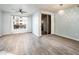Airy living room featuring hardwood floors, a ceiling fan, and a sliding closet door at 5303 N 7Th St # 109, Phoenix, AZ 85014