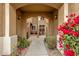 Inviting entryway with an arched entrance, desert landscaping, and a charming gate leading to a cozy courtyard at 5415 E Mckellips Rd # 24, Mesa, AZ 85215