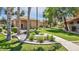 Home's exterior with lush lawn, palm trees, and a serene curb appeal at 5415 E Mckellips Rd # 24, Mesa, AZ 85215