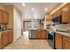 Open-concept kitchen with stainless steel dishwasher, range, and wood cabinetry, and backyard access at 5415 E Mckellips Rd # 24, Mesa, AZ 85215