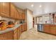 Open-concept kitchen boasting wood cabinets, stainless steel dishwasher, and spacious countertops at 5415 E Mckellips Rd # 24, Mesa, AZ 85215