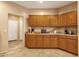 Bright kitchen features ample wood cabinetry, tile floors, and modern appliances at 5415 E Mckellips Rd # 24, Mesa, AZ 85215