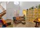 Bright living room featuring a high ceiling, neutral walls, and comfortable seating with tile floors and a staircase at 5415 E Mckellips Rd # 24, Mesa, AZ 85215