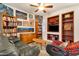 Cozy living room with built-in bookshelves, a ceiling fan, and comfortable seating, perfect for relaxation and entertainment at 5415 E Mckellips Rd # 24, Mesa, AZ 85215