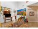 Bright living room featuring a high ceiling, neutral walls, and comfortable seating with tile floors and a tapestry wall hanging at 5415 E Mckellips Rd # 24, Mesa, AZ 85215