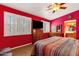 The main bedroom includes a ceiling fan, wood floors, TV, dresser, and bright windows at 5415 E Mckellips Rd # 24, Mesa, AZ 85215