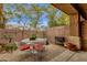 Covered patio with a wrought iron table set and views of the landscaped yard at 5415 E Mckellips Rd # 24, Mesa, AZ 85215