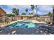 Community pool with palm trees, lounge chairs, and a bath house under a sunny blue sky at 5415 E Mckellips Rd # 24, Mesa, AZ 85215