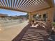 Community outdoor kitchen with a stone countertop, a built in grill, and dining area by the pool at 5450 E Mclellan Rd # 131, Mesa, AZ 85205