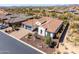 Aerial view of a single-Gathering home with a tile roof, a three-car garage and desert landscaping at 5810 E Calle Marita E --, Cave Creek, AZ 85331