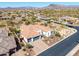 An aerial view shows the expansive home, the desert landscaping, and the nearby mountains at 5810 E Calle Marita E --, Cave Creek, AZ 85331