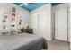 Cozy bedroom with a gray quilt bed, white shelves, and a blue ceiling at 5810 E Calle Marita E --, Cave Creek, AZ 85331