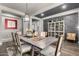 Dining area with a gray wood table, stone accent wall, and decorative display cabinet at 5810 E Calle Marita E --, Cave Creek, AZ 85331