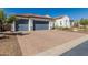 Spacious driveway with three-car garage and well-maintained landscaping in front of a charming home at 5810 E Calle Marita E --, Cave Creek, AZ 85331