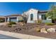 A landscaped front yard with desert foliage with a home that has a three-car garage and a desert-style roof at 5810 E Calle Marita E --, Cave Creek, AZ 85331