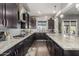 Gourmet kitchen with stainless steel appliances, granite counters, large island, and dark wood cabinetry at 5810 E Calle Marita E --, Cave Creek, AZ 85331