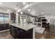 Open concept kitchen with dark wood cabinets, a granite island, and seamless flow into living area at 5810 E Calle Marita E --, Cave Creek, AZ 85331