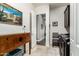 Well-lit laundry room with dark cabinets, stylish decor, tile floors, and direct access to hallway at 5810 E Calle Marita E --, Cave Creek, AZ 85331