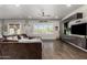Spacious living room with a large sectional sofa, hardwood floors, and ample natural light at 5810 E Calle Marita E --, Cave Creek, AZ 85331