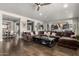 Spacious living room with a large brown couch, hardwood floors, and an open layout perfect for entertaining at 5810 E Calle Marita E --, Cave Creek, AZ 85331