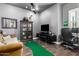 Office with a TV, couch, chair, putting green, and hardwood floors at 5810 E Calle Marita E --, Cave Creek, AZ 85331