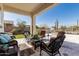 Inviting covered patio featuring wicker furniture, desert landscaping, and a peaceful seating area at 5810 E Calle Marita E --, Cave Creek, AZ 85331