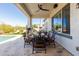 Outdoor covered patio overlooking well-manicured artificial turf, pool, and luxurious lounge chairs at 5810 E Calle Marita E --, Cave Creek, AZ 85331