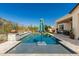 Sparkling pool featuring a Baja shelf and umbrella, complemented by a travertine patio and desert landscaping at 5810 E Calle Marita E --, Cave Creek, AZ 85331
