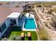 Aerial view of backyard oasis with pool, lounge area, outdoor kitchen, and desert landscaping at 5810 E Calle Marita E --, Cave Creek, AZ 85331