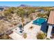 Aerial view of backyard oasis featuring a pool, outdoor kitchen with grill and bar, and desert landscaping at 5810 E Calle Marita E --, Cave Creek, AZ 85331
