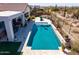 Aerial view of backyard featuring a sparkling pool, outdoor kitchen with grill, and desert views at 5810 E Calle Marita E --, Cave Creek, AZ 85331