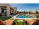Inviting pool area with lounge chairs, well-maintained turf, desert landscaping, and covered patio at 5810 E Calle Marita E --, Cave Creek, AZ 85331