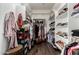 Organized walk-in closet featuring hardwood floors, built-in shelving, and ample storage for clothes and shoes at 5810 E Calle Marita E --, Cave Creek, AZ 85331