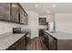 Well-equipped kitchen with granite countertops, stainless appliances, a central island, and dark wood cabinetry at 619 W Pintail Dr, Casa Grande, AZ 85122