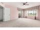 Large bedroom featuring wall to wall carpet, ceiling fan and a sliding glass door to the outside at 6391 S Championship Dr, Chandler, AZ 85249