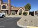 Charming tan home featuring a brick chimney, rock landscaping and a well-manicured lawn at 7905 W Thunderbird Rd # 294, Peoria, AZ 85381