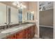 Bathroom with double vanity, granite counters, and ample cabinet space at 8260 N Buena Vista Dr, Casa Grande, AZ 85194