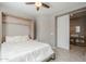 Comfortable bedroom featuring a Murphy bed and a door leading to the bathroom at 830 E Garden Basket Dr, Queen Creek, AZ 85140