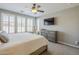 Bright bedroom with plantation shutters, tile floors, and a ceiling fan at 830 E Garden Basket Dr, Queen Creek, AZ 85140