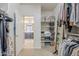 Spacious walk-in closet with ample storage space, shelving, and rods for organized living at 830 E Garden Basket Dr, Queen Creek, AZ 85140