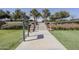 Beautiful community park with palm trees and stairs leading to elevated area with neighborhood information at 830 E Garden Basket Dr, Queen Creek, AZ 85140