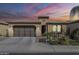 Charming single-story home featuring desert landscaping, a two-car garage, and a warm, inviting facade at 830 E Garden Basket Dr, Queen Creek, AZ 85140